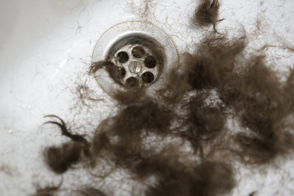 bathroom sink drain with hair and soap buildup